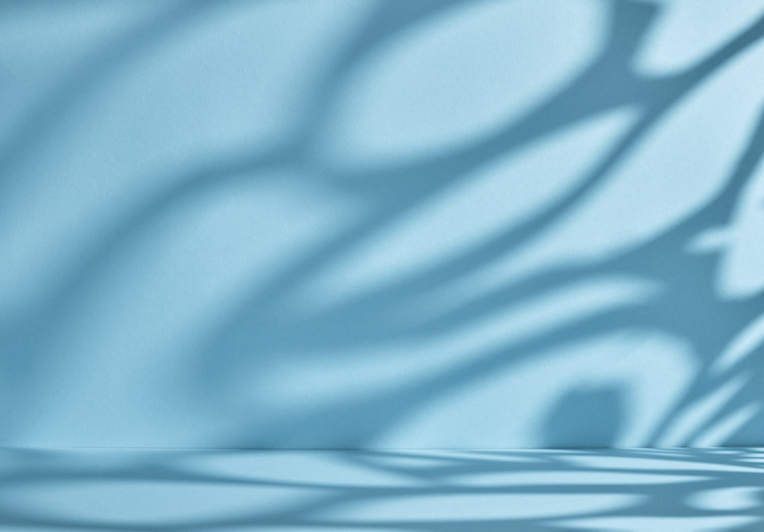 Abstract blue background with soft, curved shadows creating an organic pattern.